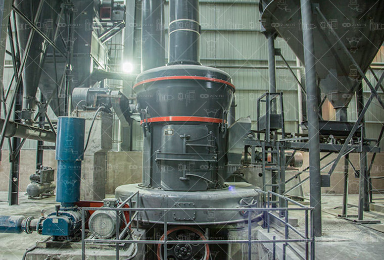 Close-up view of fine Neodymium Iron Boron powder flowing from a grinding mill discharge.
